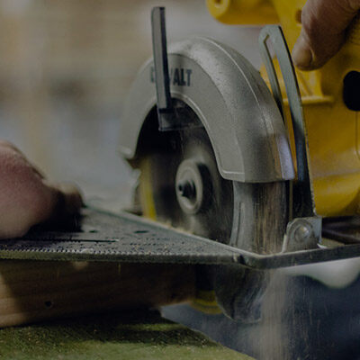 A saw and a hammer on a wooden workbench